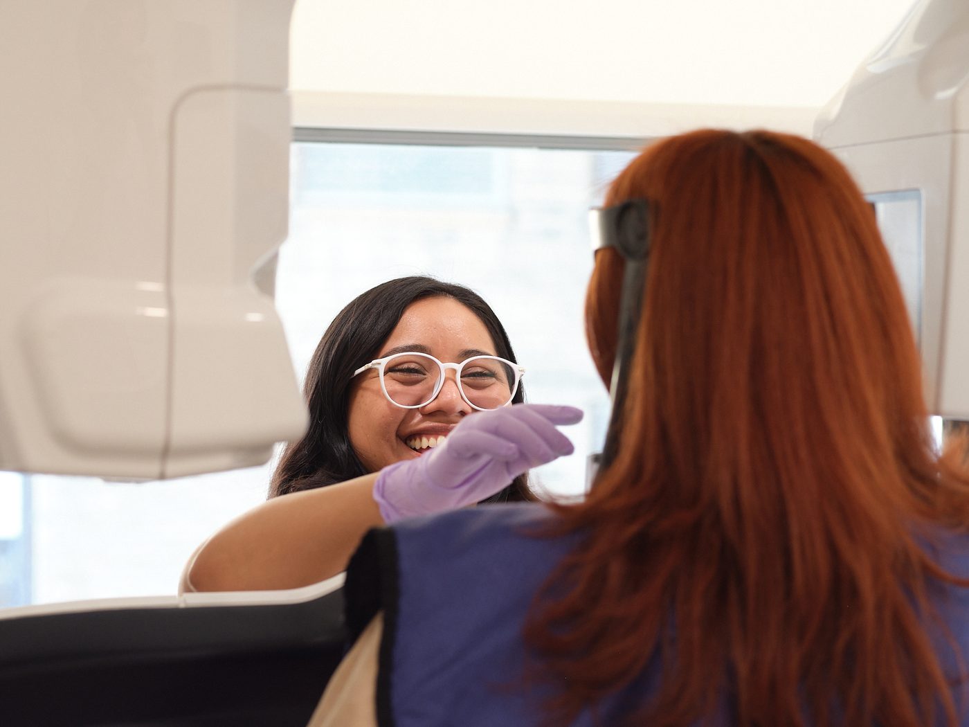 A periodontal assistant helping a patient get comfortable