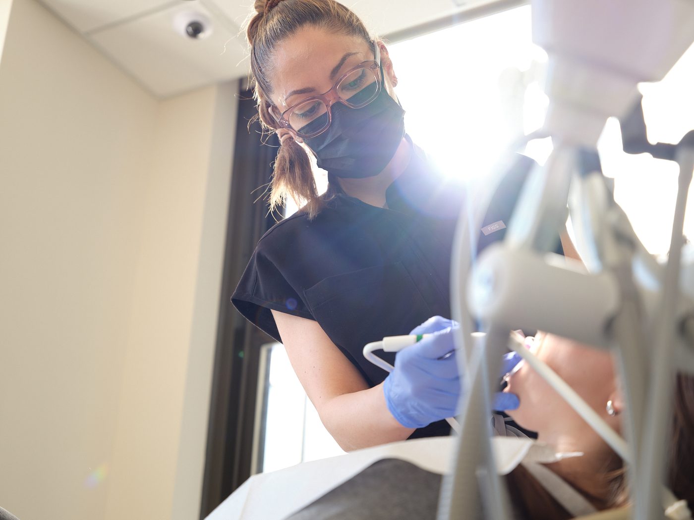 A hygienist providing gentle periodontal maintenance