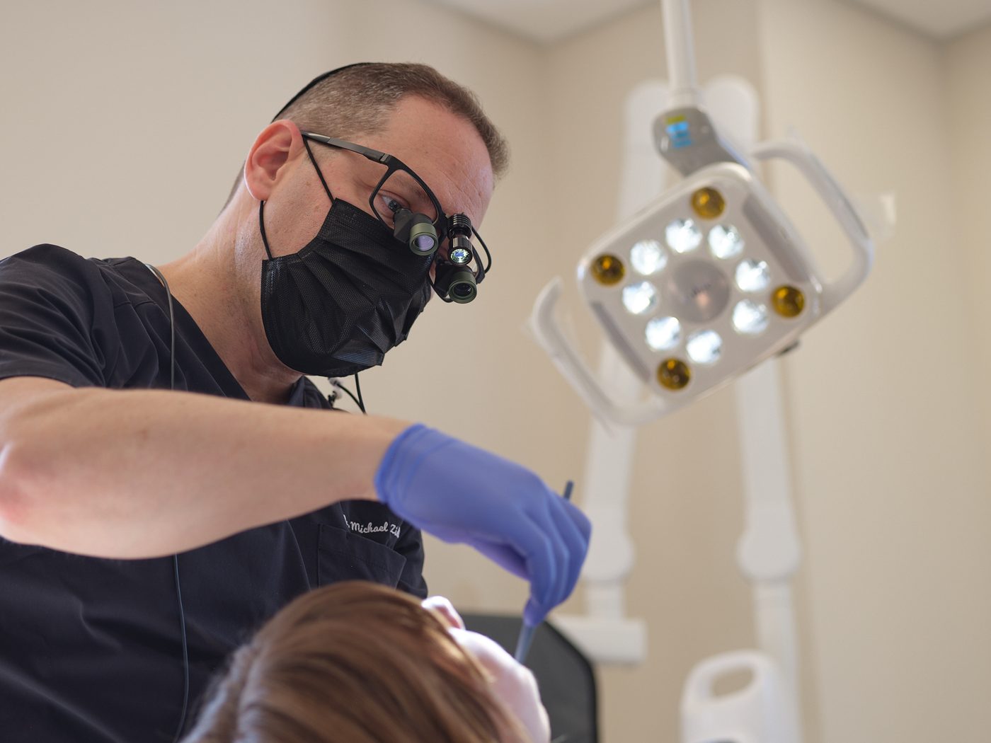 Dr. Zidile performing precise periodontal surgery